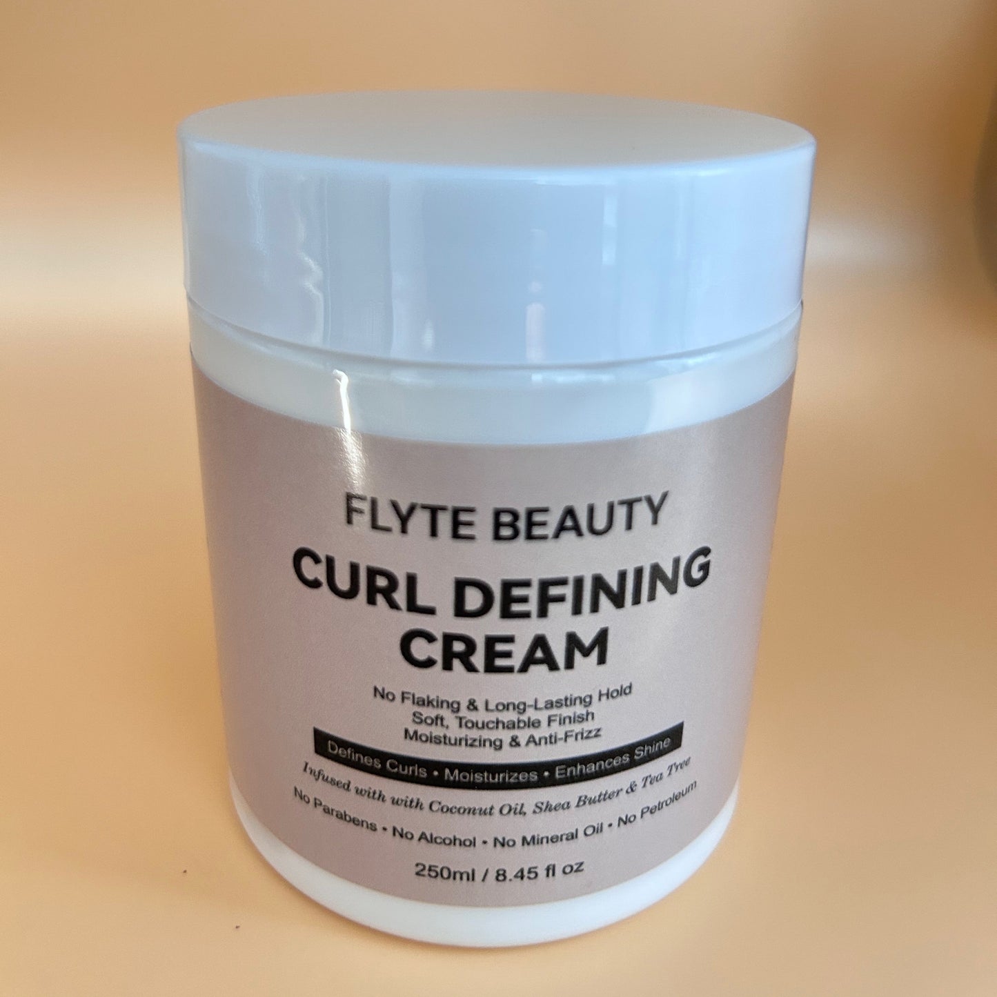 Jar of Flyte Beauty Curl Defining Cream on a beige background