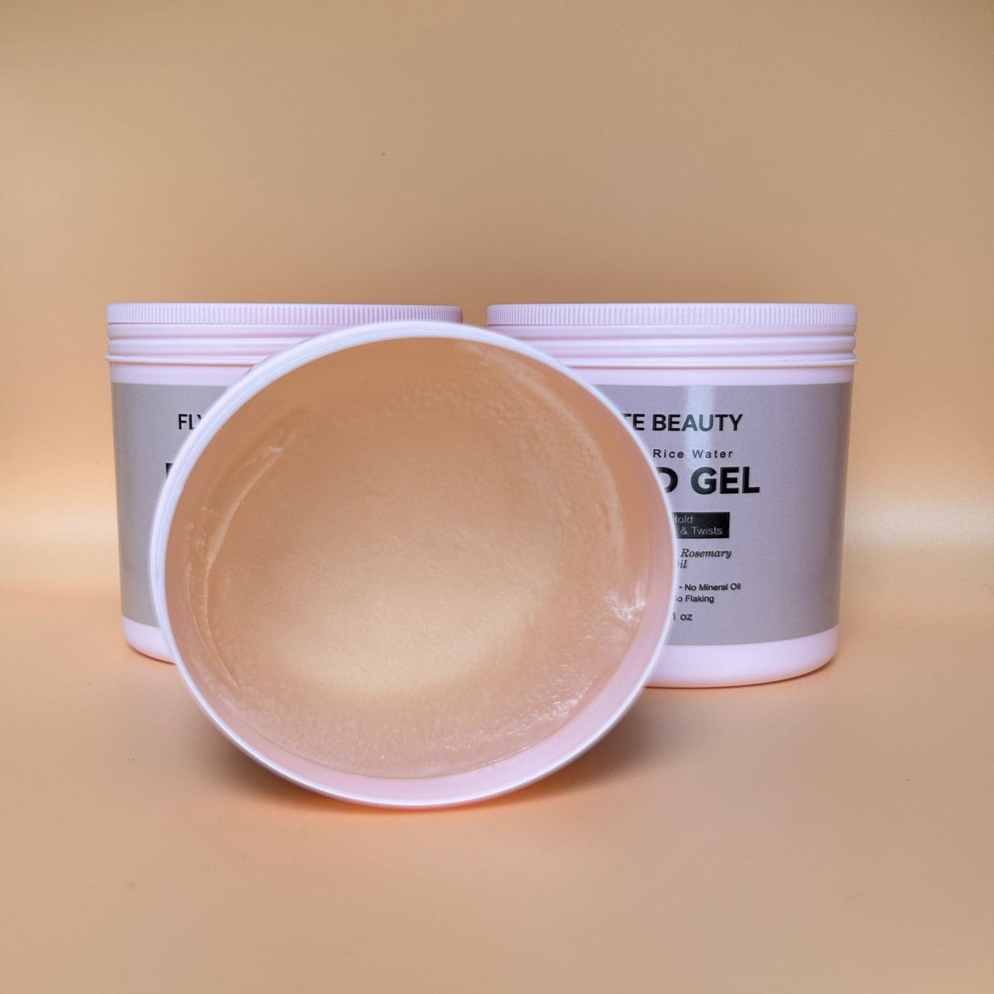Two containers of 'F lime Beauty' hair gel on a beige background